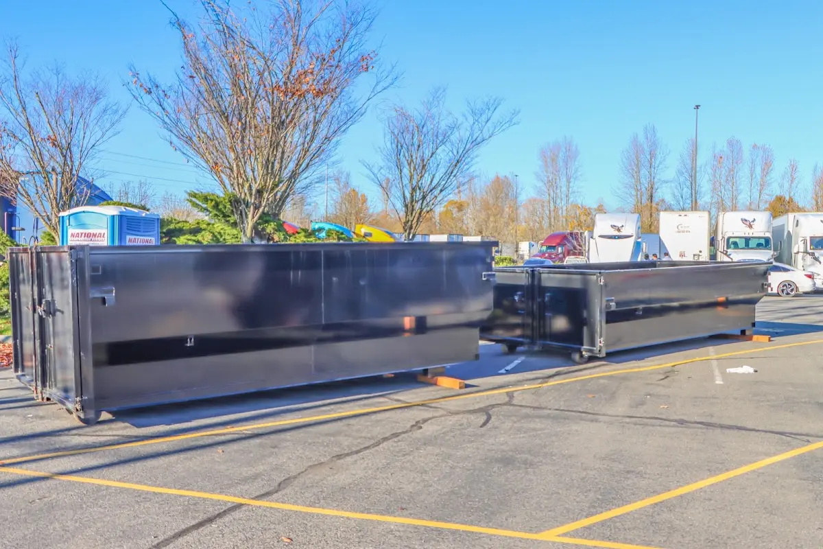 Professional dumpster rental service with roll-off container on residential driveway in Avondale